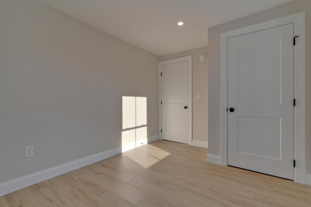 unfurnished bedroom featuring light wood-type flooring