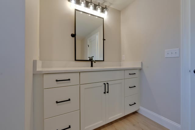 bathroom featuring vanity and hardwood / wood-style floors