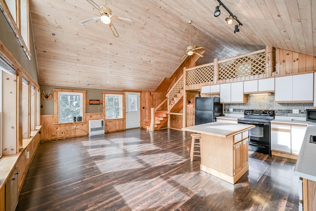 kitchen featuring white cabinetry, a kitchen island, wood ceiling, and black appliances