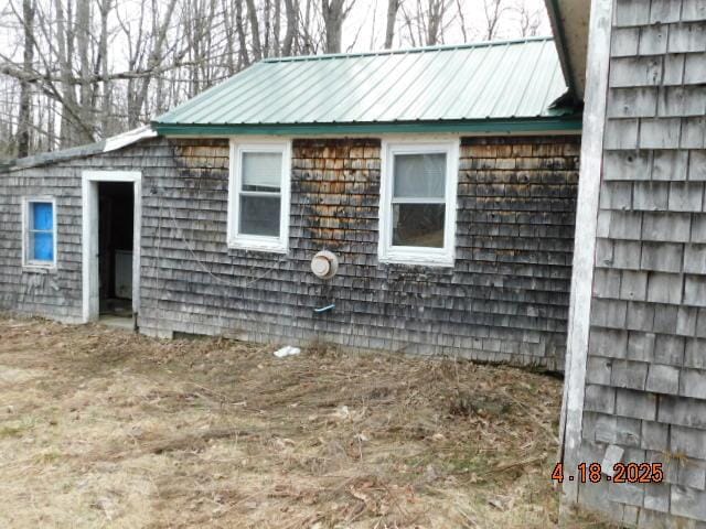 view of side of property with metal roof
