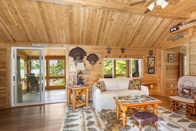 living room featuring wood walls, hardwood / wood-style floors, vaulted ceiling with beams, and wood ceiling