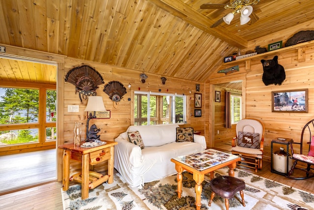 living room featuring wood walls, hardwood / wood-style floors, vaulted ceiling with beams, and wooden ceiling
