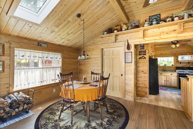 dining room with ceiling fan, beam ceiling, wood ceiling, hardwood / wood-style floors, and wood walls