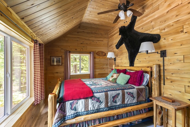 bedroom with wood-type flooring, ceiling fan, wood ceiling, wooden walls, and lofted ceiling
