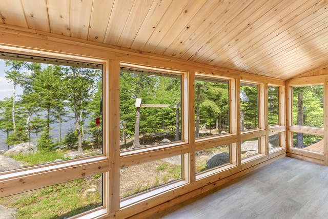 unfurnished sunroom featuring wooden ceiling, lofted ceiling, and a healthy amount of sunlight