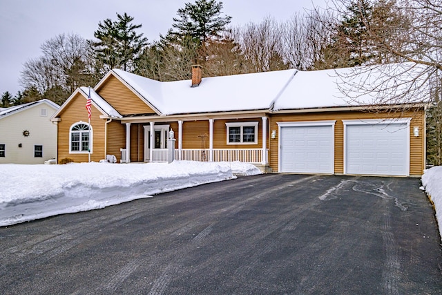 ranch-style home with a garage and a porch