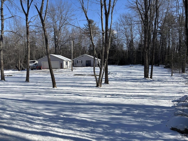 yard layered in snow with a garage