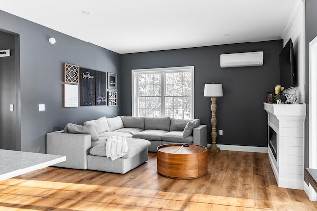 living room featuring hardwood / wood-style flooring and an AC wall unit