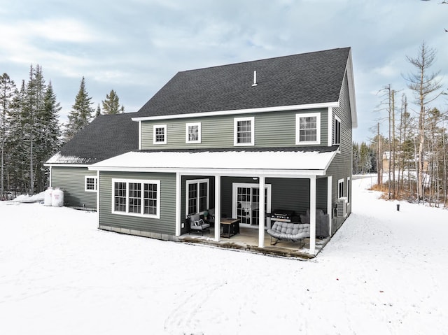 view of snow covered rear of property