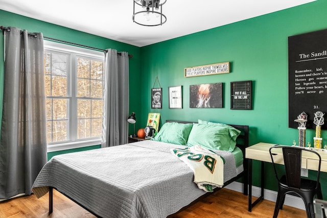 bedroom with wood-type flooring