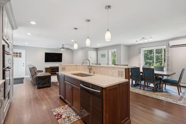 kitchen with sink, decorative light fixtures, dishwasher, an island with sink, and ceiling fan