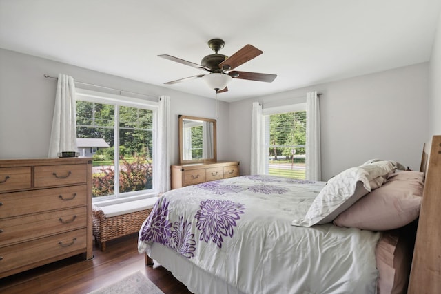 bedroom with dark hardwood / wood-style floors and ceiling fan