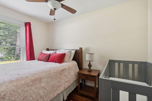 bedroom with ceiling fan and dark hardwood / wood-style flooring