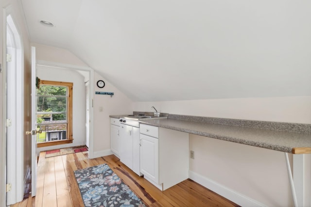 laundry area featuring sink and light hardwood / wood-style flooring