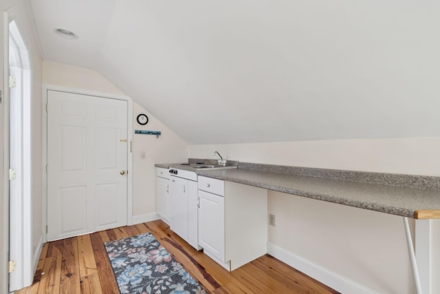 clothes washing area featuring sink and light hardwood / wood-style flooring