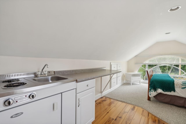 kitchen featuring white cabinetry, sink, light hardwood / wood-style flooring, and vaulted ceiling