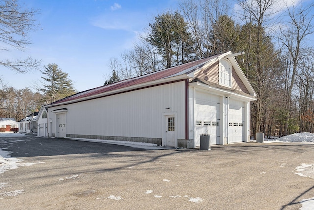 view of property exterior featuring an outbuilding and a garage