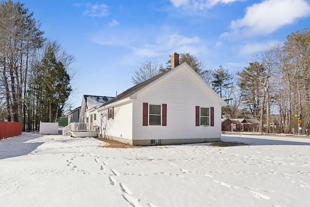 view of snow covered exterior with a wooden deck