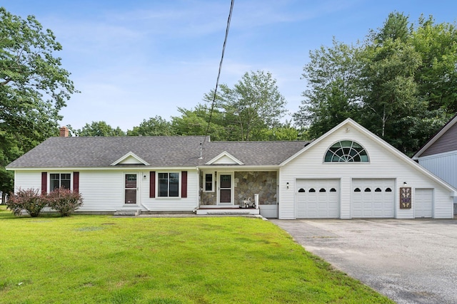 view of front of property with a chimney, aphalt driveway, a front yard, and roof with shingles
