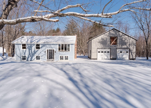 snow covered structure with a garage