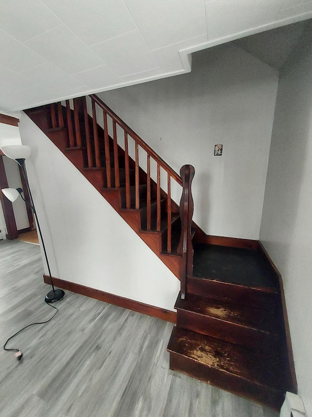 stairs with hardwood / wood-style floors