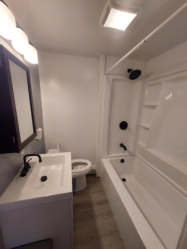 full bathroom with vanity, hardwood / wood-style floors, shower / bathtub combination, and toilet