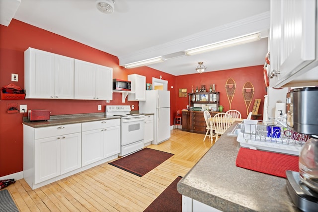 kitchen with white cabinetry, white appliances, and light hardwood / wood-style flooring