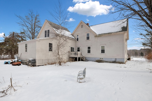 snow covered property featuring a wooden deck