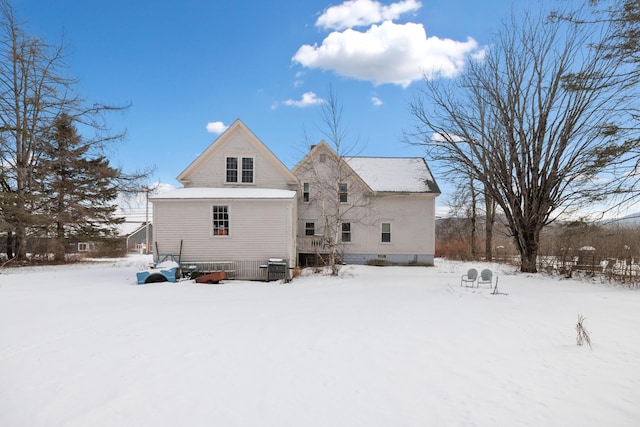 snow covered back of property with central air condition unit