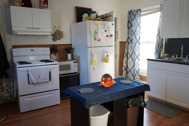 kitchen featuring sink, dark wood-type flooring, white cabinets, white appliances, and range hood