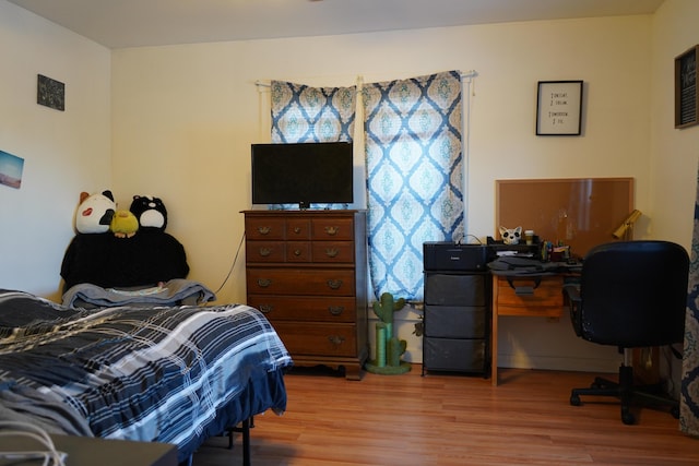 bedroom with wood-type flooring