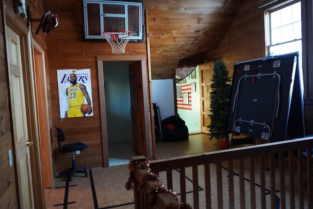 interior space featuring wooden ceiling, wooden walls, and lofted ceiling