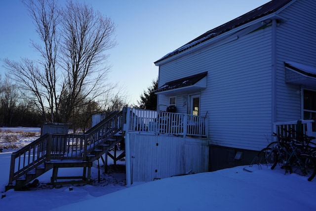 snow covered property featuring a deck