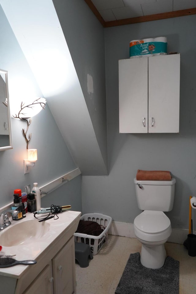 bathroom featuring toilet and vanity