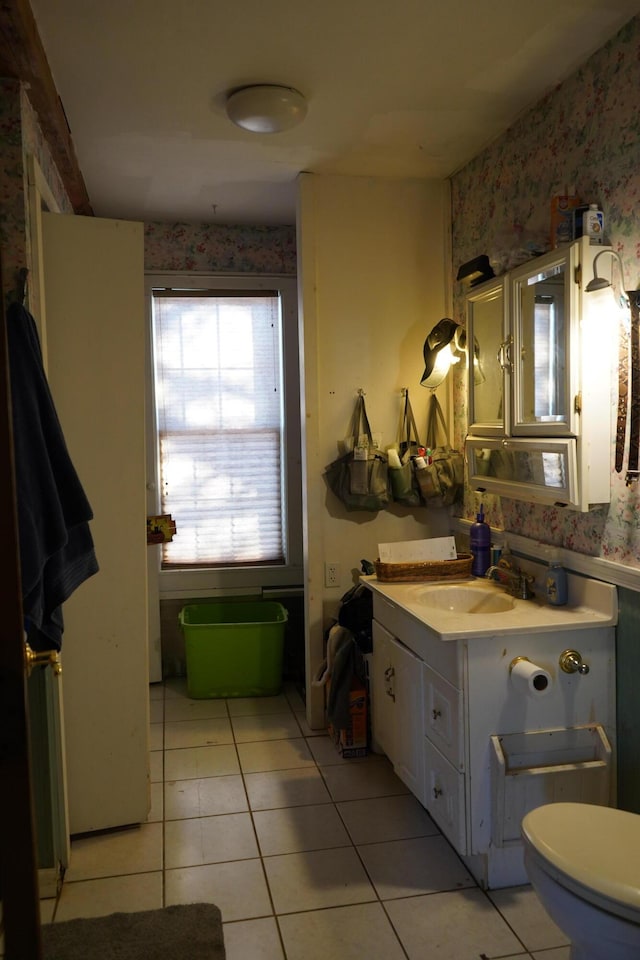 bathroom featuring toilet, tile patterned floors, and vanity