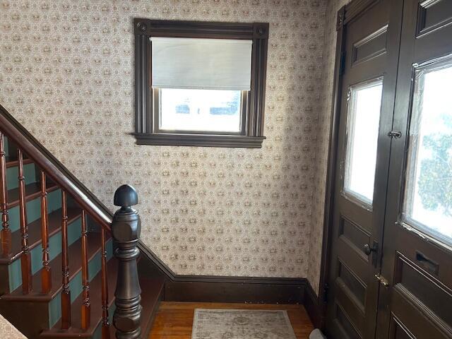 foyer with hardwood / wood-style flooring and french doors