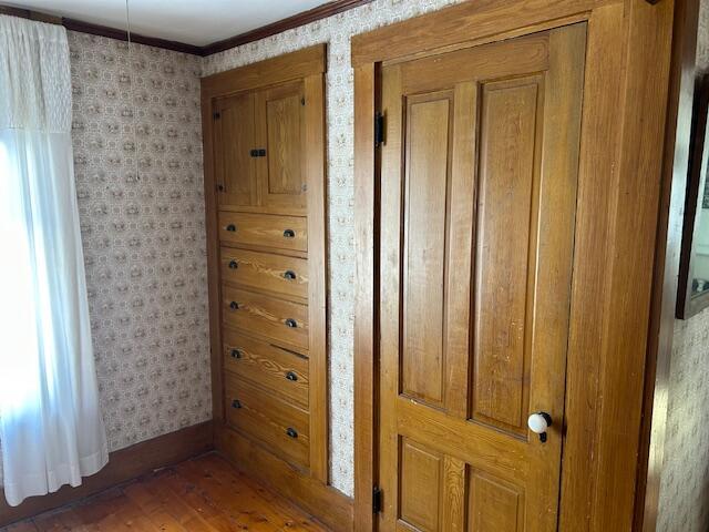 interior space with crown molding and dark hardwood / wood-style flooring