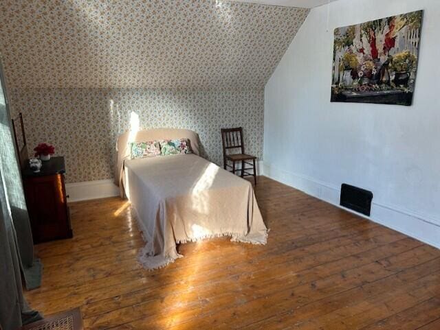 bedroom with dark wood-type flooring