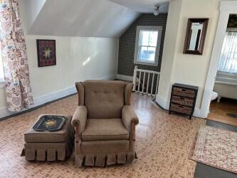 sitting room featuring vaulted ceiling