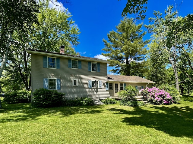 back of house featuring a yard