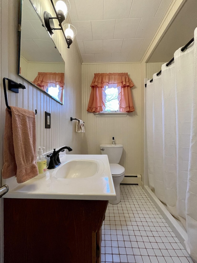 bathroom featuring vanity, toilet, baseboard heating, and a shower with shower curtain