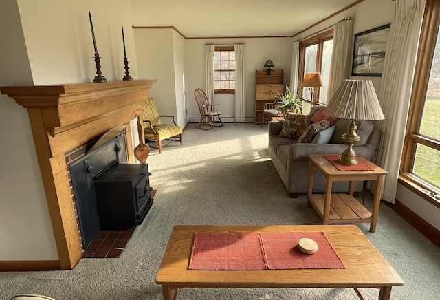 carpeted living room with crown molding, a wood stove, and a wealth of natural light