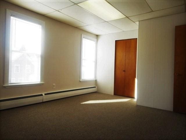 spare room featuring a paneled ceiling and baseboard heating