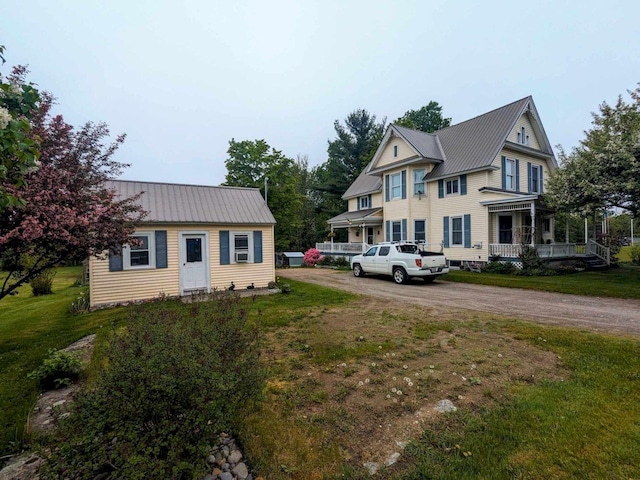 exterior space with covered porch and a front yard