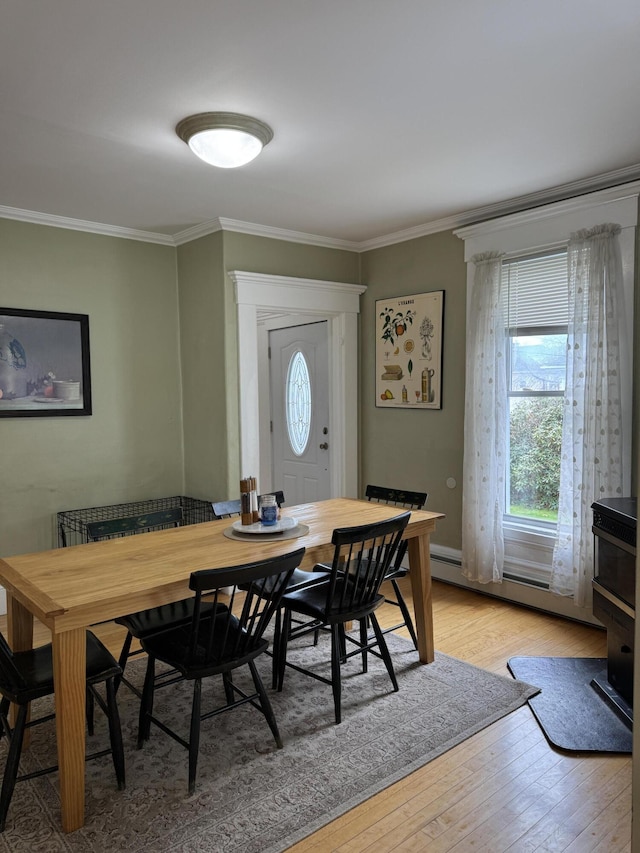 120 Birch St, Bangor, ME 04401 - dining space with ornamental molding, light wood-style floors, and a baseboard heating unit