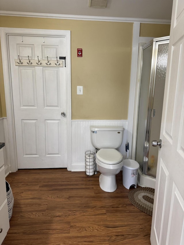120 Birch St, Bangor, ME 04401 - bathroom with a shower stall, wainscoting, wood finished floors, ornamental molding, and toilet