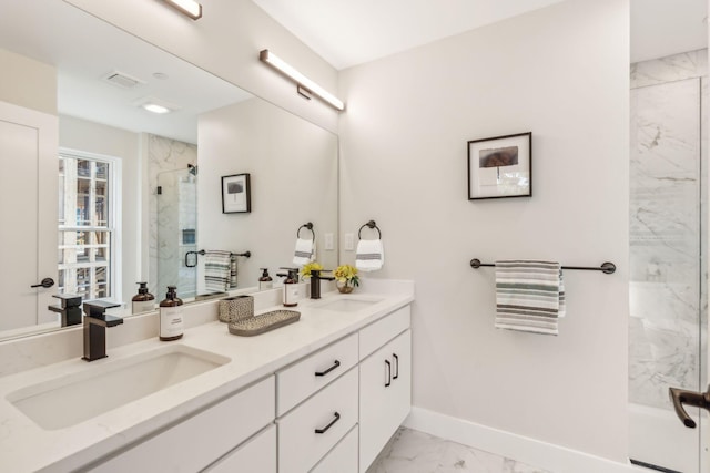 bathroom with vanity and a shower with door