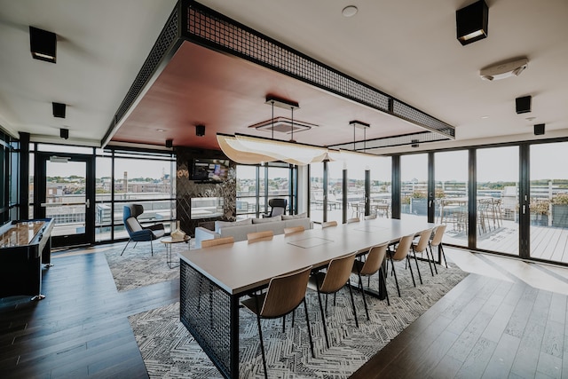 dining space featuring french doors, expansive windows, and hardwood / wood-style flooring