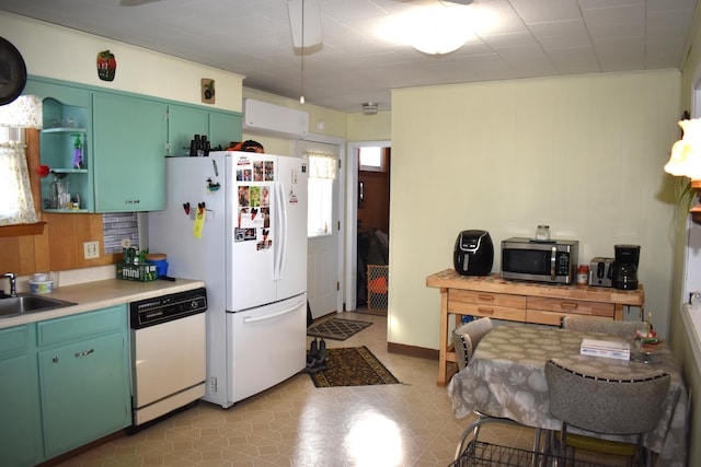 kitchen featuring white appliances and sink