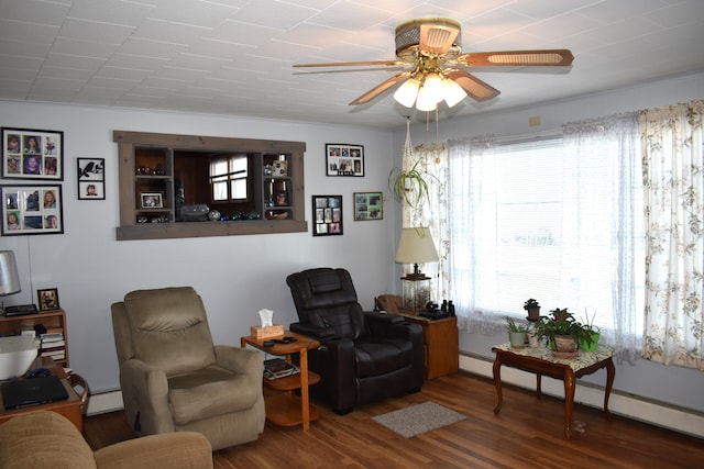 living area featuring hardwood / wood-style floors, ceiling fan, and baseboard heating